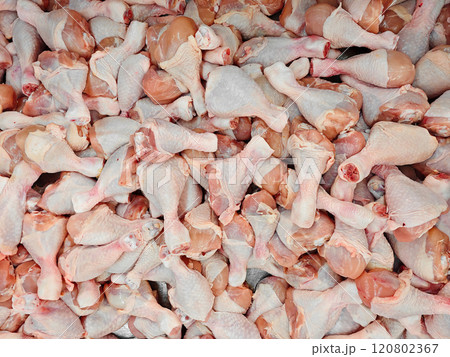 Fresh Raw Chicken Drumsticks Piled in a Market Display 120802367