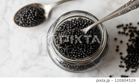 Black Caviar in Glass Jar with Silver Spoon 120804529