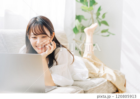 ソファで寝転がりながらパソコンを使う女性 ソファで寝転がりながらパソコンを使う女性 120805913