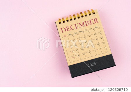 December 2025 desk calendar on pink color background, Position with copy space. 120806710