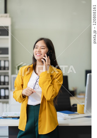 Portrait of a successful business woman with inspiration from their excellent financial results front at the desk, looking to camera. Portrait of a successful business woman with inspiration from their excellent financial results front at the desk, looking to camera. 120808161