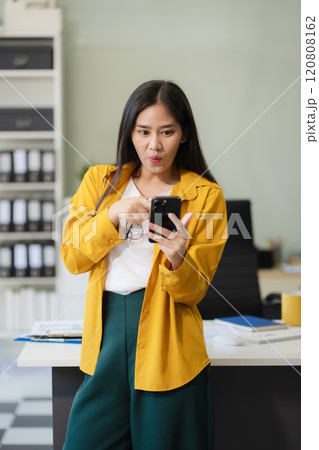 Portrait of a successful business woman with inspiration from their excellent financial results front at the desk, looking to camera. 120808162