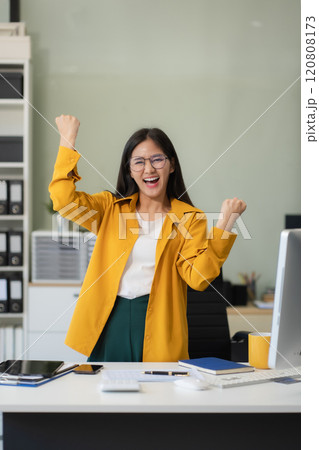 Portrait of a successful business woman with inspiration from their excellent financial results front at the desk, looking to camera. 120808173