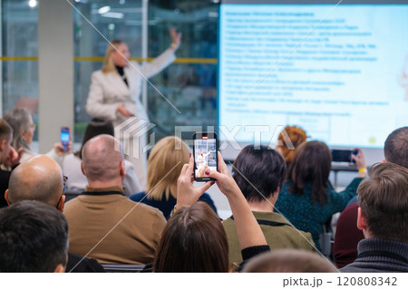 Audience capturing presentation with smartphones during business seminar Audience capturing presentation with smartphones during business seminar 120808342