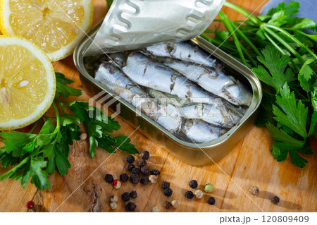 Tin can with smoked sprats, sardines, closeup Tin can with smoked sprats, sardines, closeup 120809409