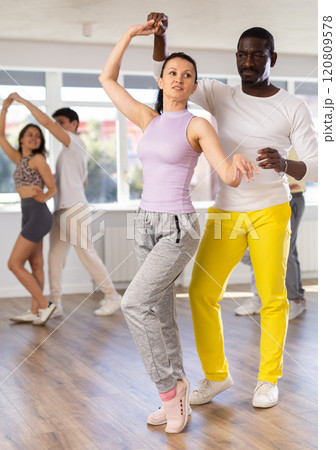 Couple male and girl rehearsing pair latino dance in studio 120809578