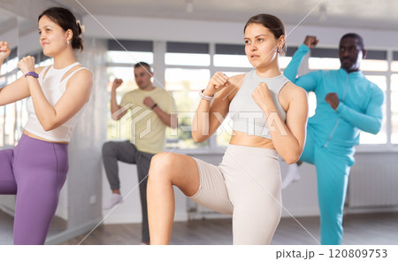 Sporty young girl in dynamic dance boxing training 120809753
