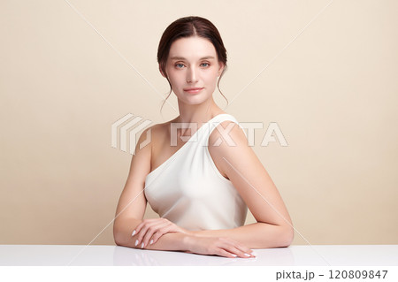 Beautiful young woman with clean fresh skin on beige background, Face care, Facial treatment, Cosmetology, beauty and spa, women portrait. Beautiful young woman with clean fresh skin on beige background, Face care, Facial treatment, Cosmetology, beauty and spa, women portrait. 120809847
