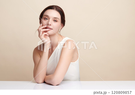 Beautiful young woman with clean fresh skin on beige background, Face care, Facial treatment, Cosmetology, beauty and spa, women portrait. Beautiful young woman with clean fresh skin on beige background, Face care, Facial treatment, Cosmetology, beauty and spa, women portrait. 120809857