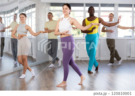 Young Asian woman dancing salsa during group class Young Asian woman dancing salsa during group class 120810001