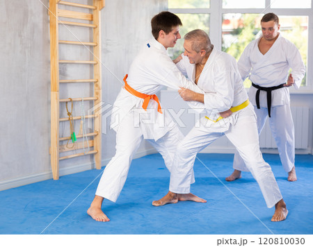 Young and elderly men training judo fight Young and elderly men training judo fight 120810030