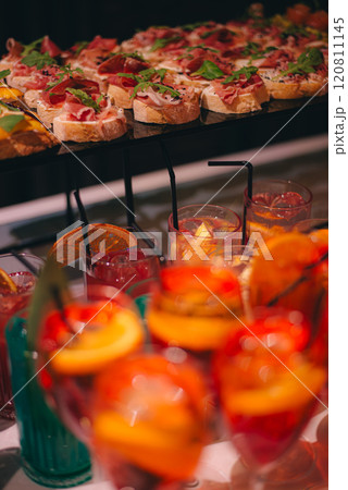 catering buffet table with snacks and appetizers. Set of canapes with jamon, bruschetta, pear and cheese catering buffet table with snacks and appetizers. Set of canapes with jamon, bruschetta, pear and cheese 120811145
