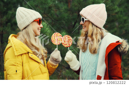 Happy smiling women friends, having fun, celebration on Christmas tree background in winter forest Happy smiling women friends, having fun, celebration on Christmas tree background in winter forest 120812222