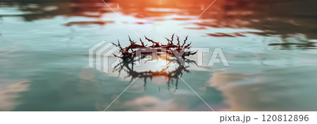 Reflection of the crown of thorns and the crown in serene water, which symbolizes Jesus' suffering and trials 120812896