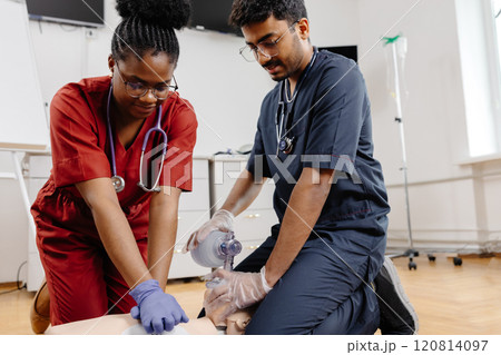 Healthcare professionals in scrubs performing medical procedure Healthcare professionals in scrubs performing medical procedure 120814097