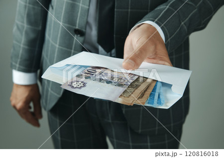 businessman offering an envelope with forints 120816018