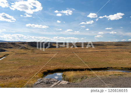Scenic Meadow and Stream Under a Cloud-Filled Sky in Yellowstone National Park. 120816035