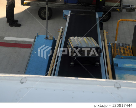 luggage being loaded in airplane 120817444