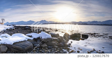Snow covered Robukta coast of Norwegian fjord near Troms at Christmas time. A sunny winter day in Northern Norway above the Arctic Circle Snow covered Robukta coast of Norwegian fjord near Troms at Christmas time. A sunny winter day in Northern Norway above the Arctic Circle 120817670