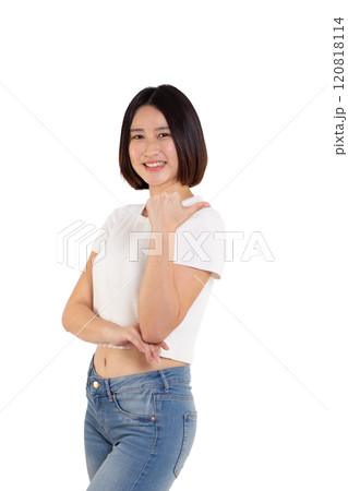 portrait of a Happy Asian woman smiling points her index finger at an empty space in the background and looks straight ahead on white background 120818114