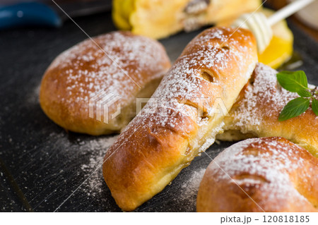 Pastries. Sweet buns with quince and honey filling, on a wooden table 120818185