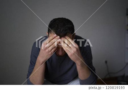 30-year-old man is stressed, holding his head with his hands 30-year-old man is stressed, holding his head with his hands 120819193