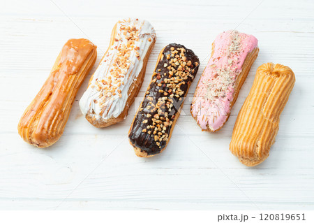 Assorted eclairs on a pastel top view Traditional French dessert Assorted eclairs on a pastel top view Traditional French dessert 120819651