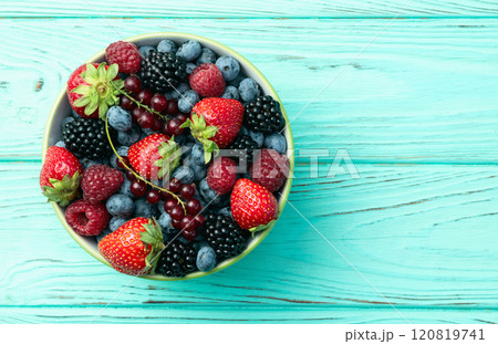 Mix of ripe colorful berries in bowl photography . Blueberry , strawberry , raspberry , blackberry and red currant . Top view Mix of ripe colorful berries in bowl photography . Blueberry , strawberry , raspberry , blackberry and red currant . Top view 120819741