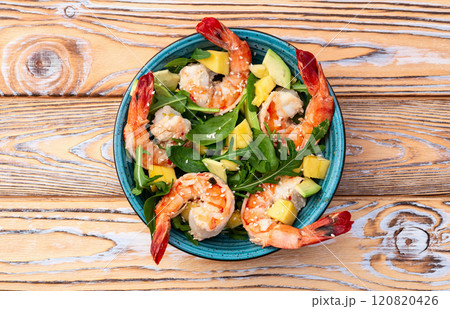 Salad with tiger shrimps , avocado and mango . Top view 120820426