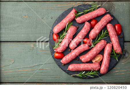 Raw beef sausages with rosemary and tomatoes photography . Top view Raw beef sausages with rosemary and tomatoes photography . Top view 120820450