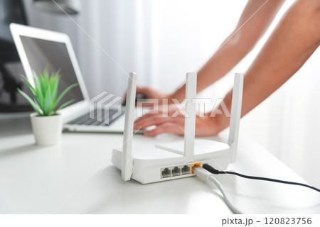 Modern wi-fi router on light table in room 120823756