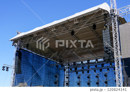 Fragment of metal trusses, lighting and sound system elements of a large outdoor concert stage Fragment of metal trusses, lighting and sound system elements of a large outdoor concert stage 120824141