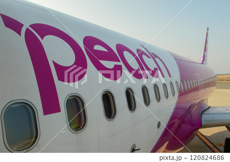 Low cost Peach Aviation planes on the runway of Kansai International Airport, artificial island in Osaka Bay in Osaka, Japan Low cost Peach Aviation planes on the runway of Kansai International Airport, artificial island in Osaka Bay in Osaka, Japan 120824686