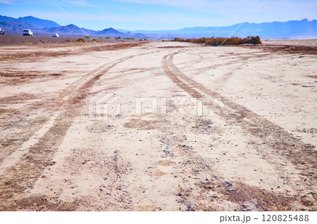 Tire Tracks in Nevada Desert with Distant Mountains Low Perspective 120825488