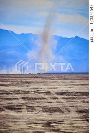 Dust Devil in Desert with Mountain Backdrop Eye-Level View Dust Devil in Desert with Mountain Backdrop Eye-Level View 120825547