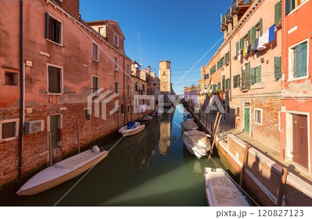 Traditional quiet canal with boats in Venice, Italy 120827123