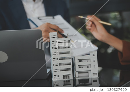 Real estate agent and customer signing contract to buy house, insurance or loan real estate.rent a house,get insurance or loan real estate or property. 120827490