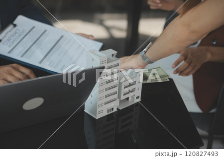 Real estate agent and customer signing contract to buy house, insurance or loan real estate.rent a house,get insurance or loan real estate or property. 120827493