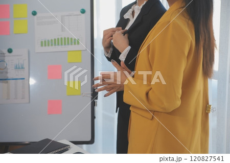 Meeting of business executives discussing analysis of the company's financial situation and business planning with partner collaboration and consultation of strategy. Meeting of business executives discussing analysis of the company's financial situation and business planning with partner collaboration and consultation of strategy. 120827541