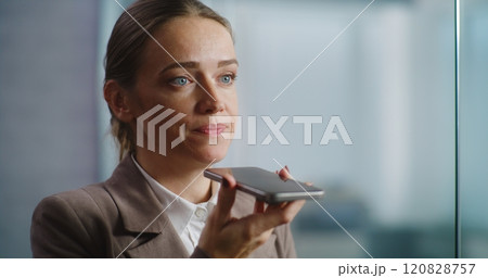 Female marketing manager records voice message in app using smartphone Female marketing manager records voice message in app using smartphone 120828757