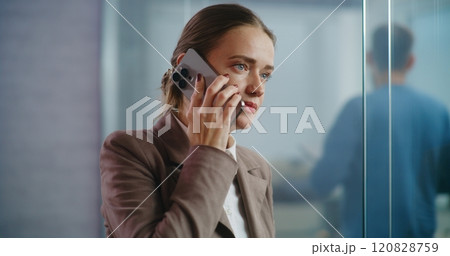 Businesswoman talks to business partner on mobile phone, discusses startup project 120828759