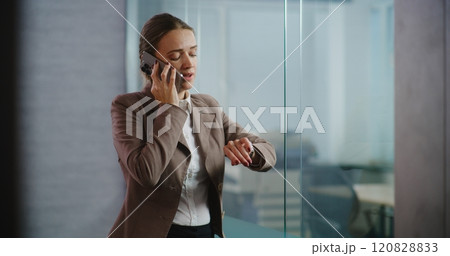 Female marketing specialist talks on mobile phone, discusses new project Female marketing specialist talks on mobile phone, discusses new project 120828833