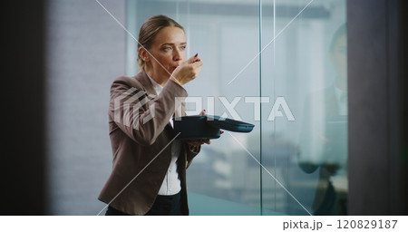 Businesswoman or office worker eats food from delivery during lunch in modern office 120829187