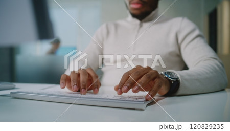 Close up of African American businessman communicating with business partner using computer Close up of African American businessman communicating with business partner using computer 120829235