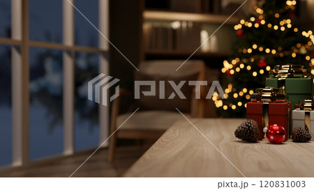 A wooden table with gift boxes and a glowing Christmas tree in a cozy living room at night. 120831003
