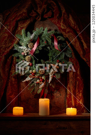 Christmas wreath and burning candles on a vintage background. Christmas wreath and burning candles on a vintage background. 120834445