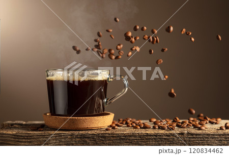 Black coffee in glass cup on an old wooden board. 120834462