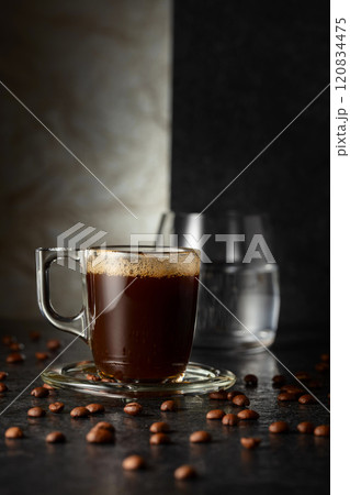 Espresso, glass of cold water, and roasted coffee beans. 120834475