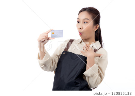 Portrait happiness young asian woman wearing apron holding credit card isolated. 120835138