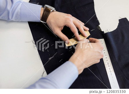 tailor marking sewing pattern on fabric 120835330